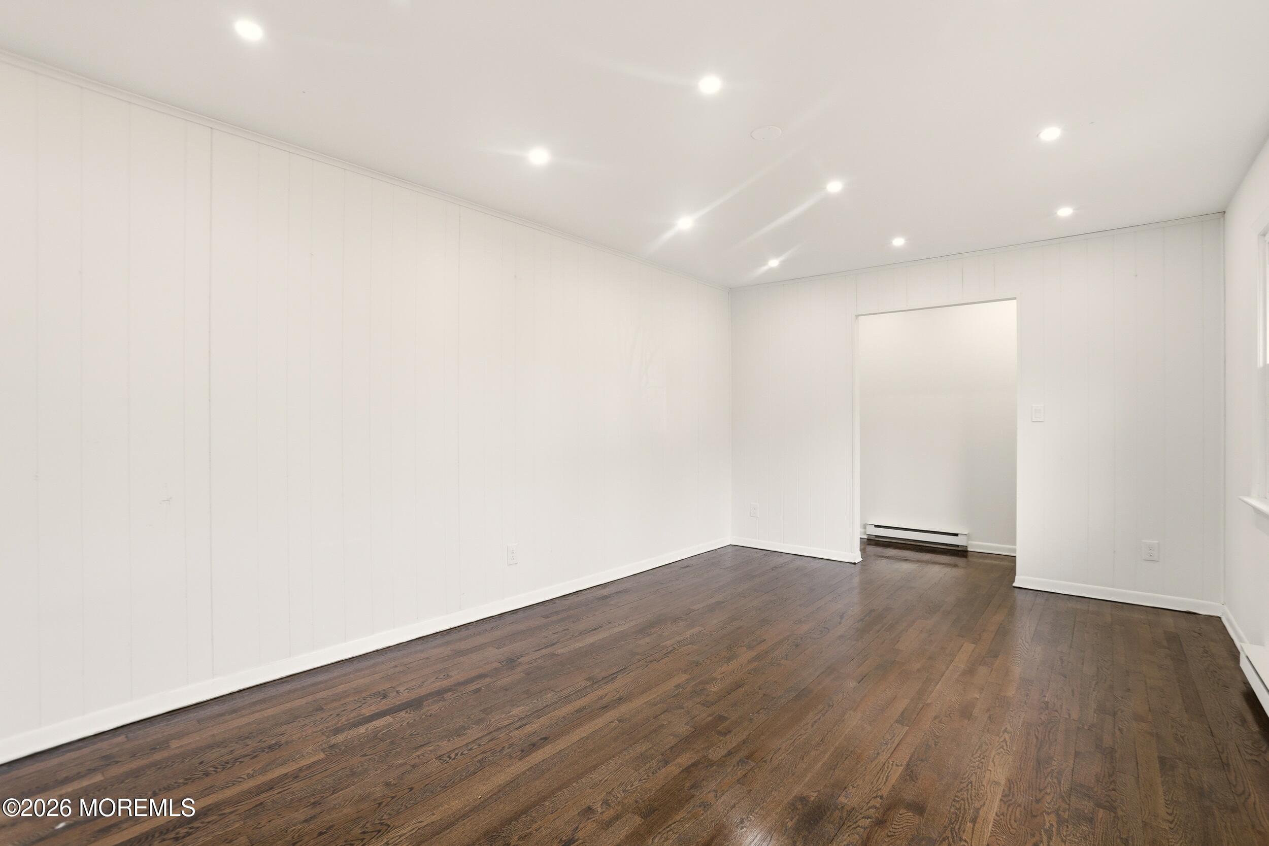 9 Riccis Drive Jackson, NJ 08527 - Photo 23 of 30 an empty room with wooden floor and windows