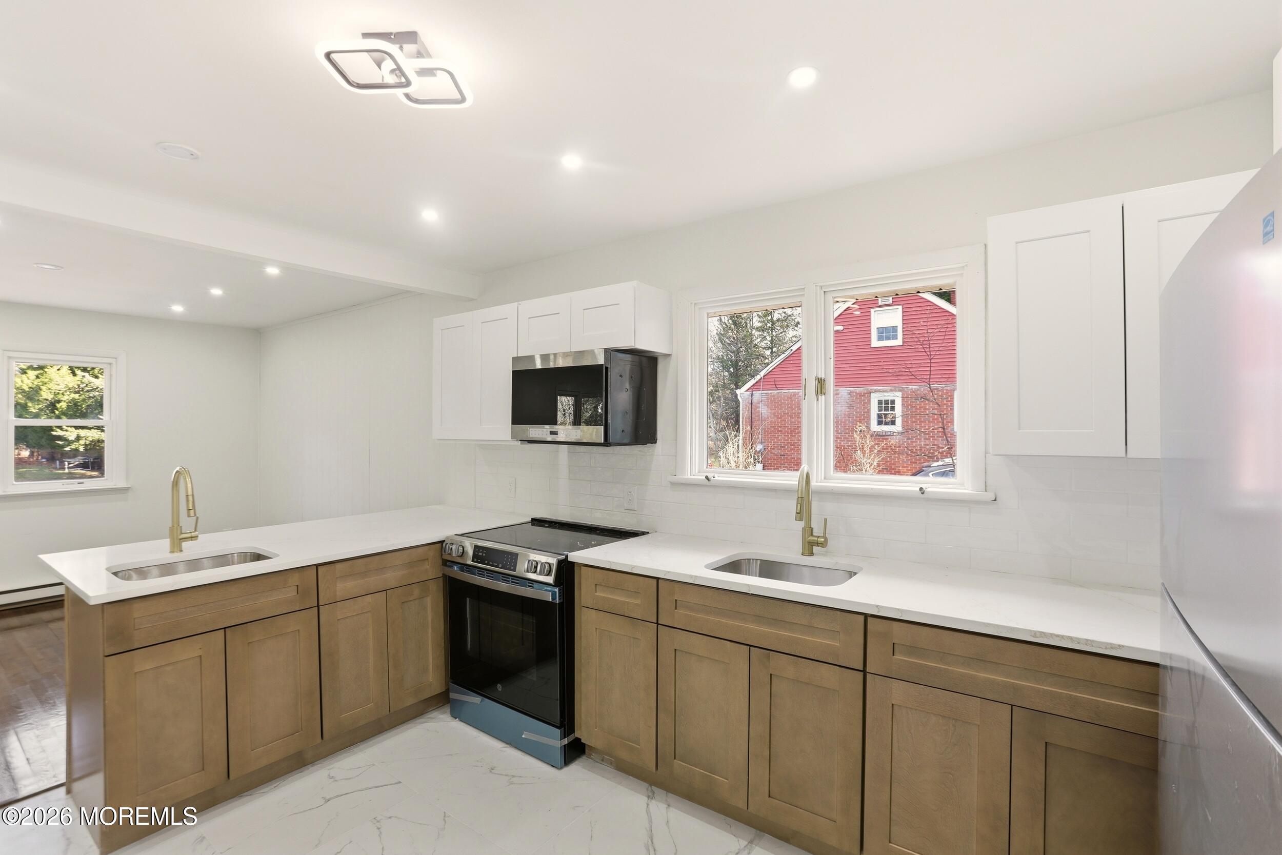 9 Riccis Drive Jackson, NJ 08527 - Photo 25 of 30 a kitchen with a sink stove and cabinets