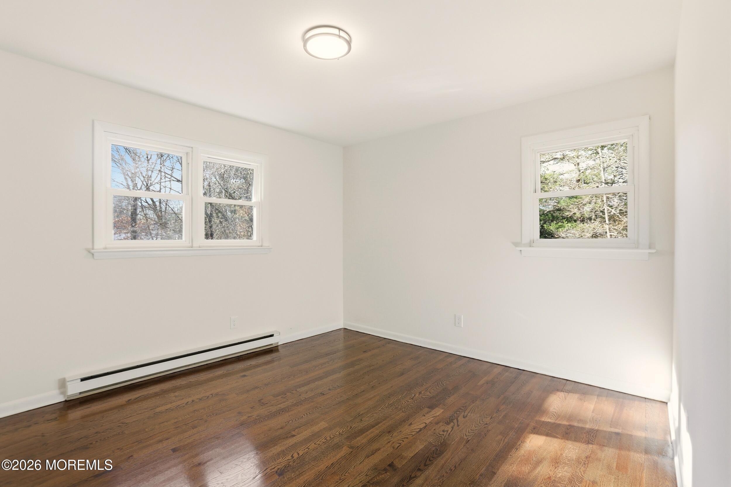 9 Riccis Drive Jackson, NJ 08527 - Photo 4 of 30 wooden floor in an empty room with a window