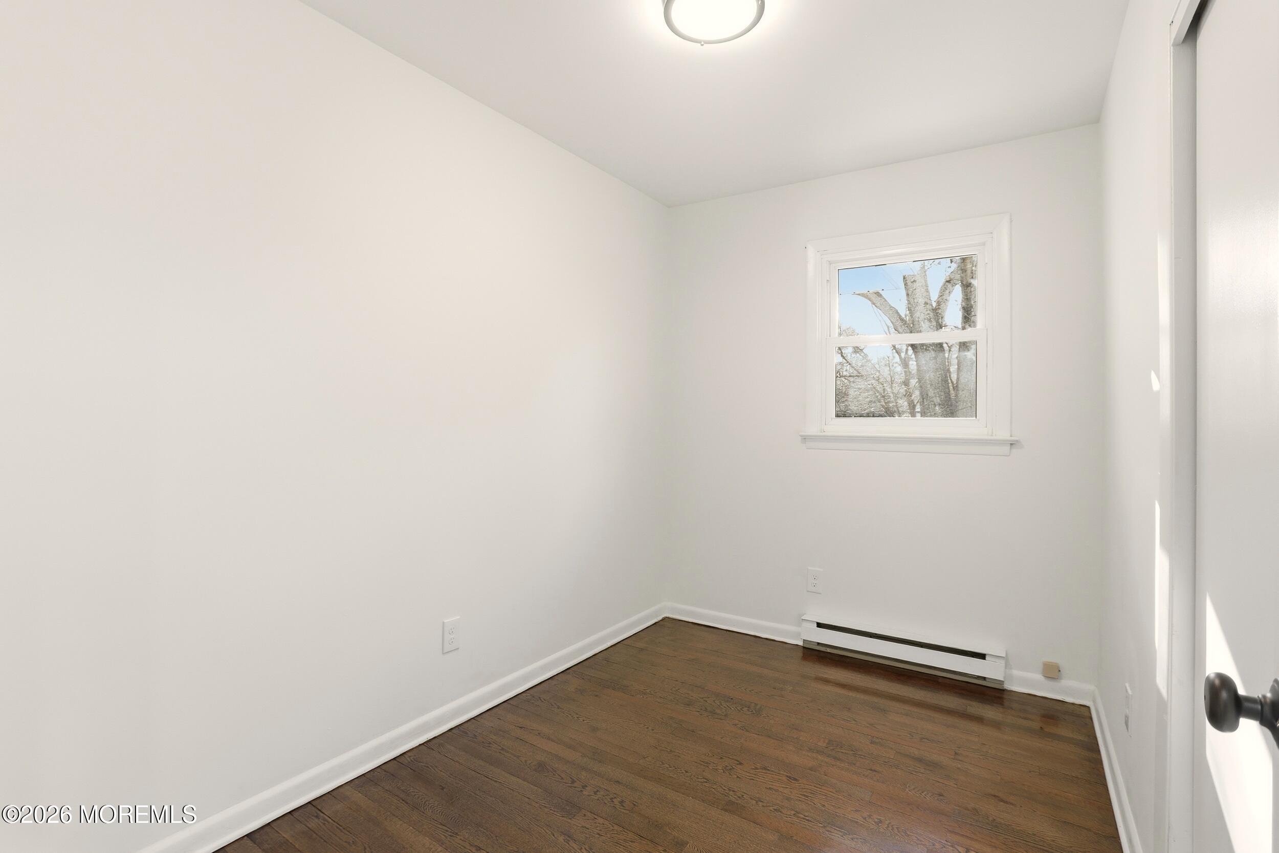9 Riccis Drive Jackson, NJ 08527 - Photo 7 of 30 a view of an empty room with wooden floor and a window