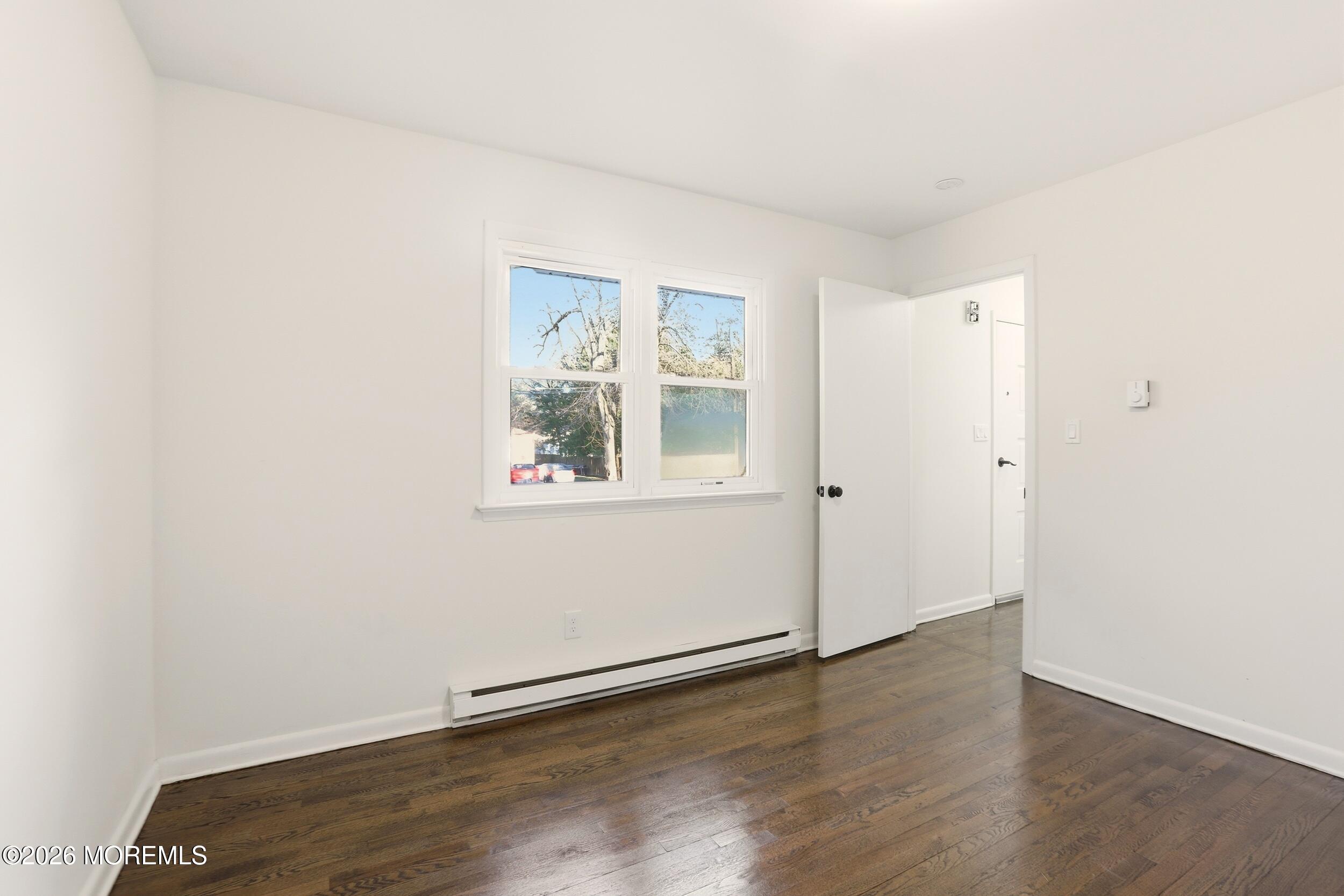 9 Riccis Drive Jackson, NJ 08527 - Photo 8 of 30 an empty room with wooden floor and windows