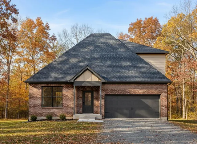 a front view of a house with a garden and yard