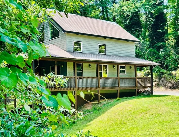 a front view of a house with a garden and porch