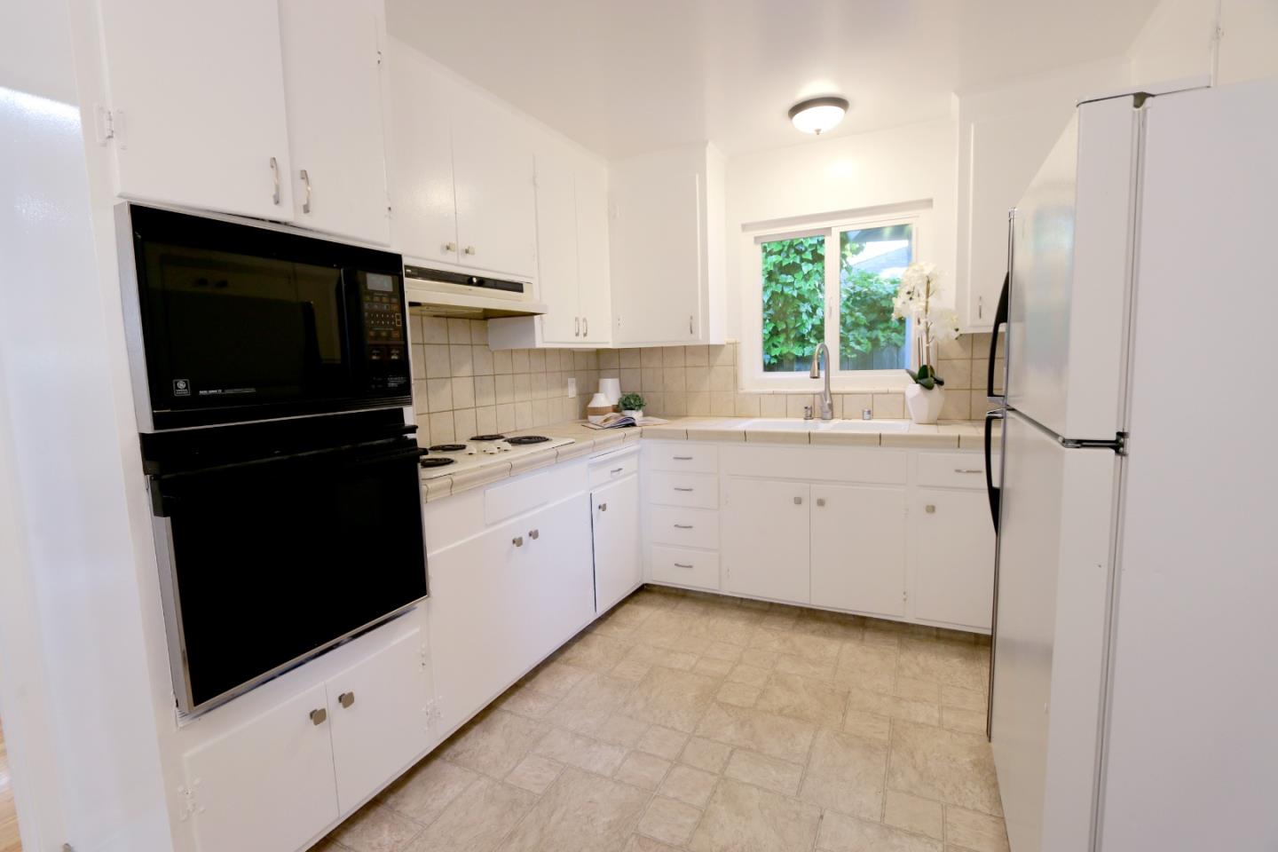 1104 Phyllis Avenue Mountain View, CA 94040 - Photo 5 of 12 a kitchen with a refrigerator and a sink
