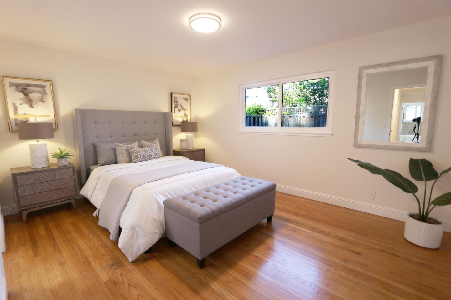 1104 Phyllis Avenue Mountain View, CA 94040 - Photo 8 of 12 a spacious bedroom with a bed and wooden floor