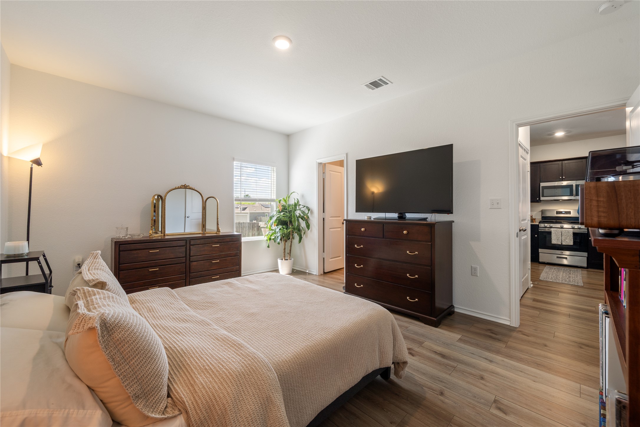 14404 Berning Road Manor, TX 78653 - Photo 16 of 38 Relax in this comfortable bedroom featuring resilient laminate flooring and a well-lit environment.
