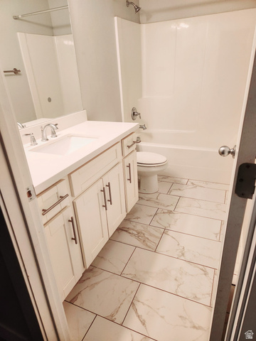 36 West Syracuse Road Vineyard, UT 84059 - Photo 55 of 56 Bathroom featuring a white vanity with an integrated sink, brushed nickel faucet, and under-sink cabinetry with modern hardware