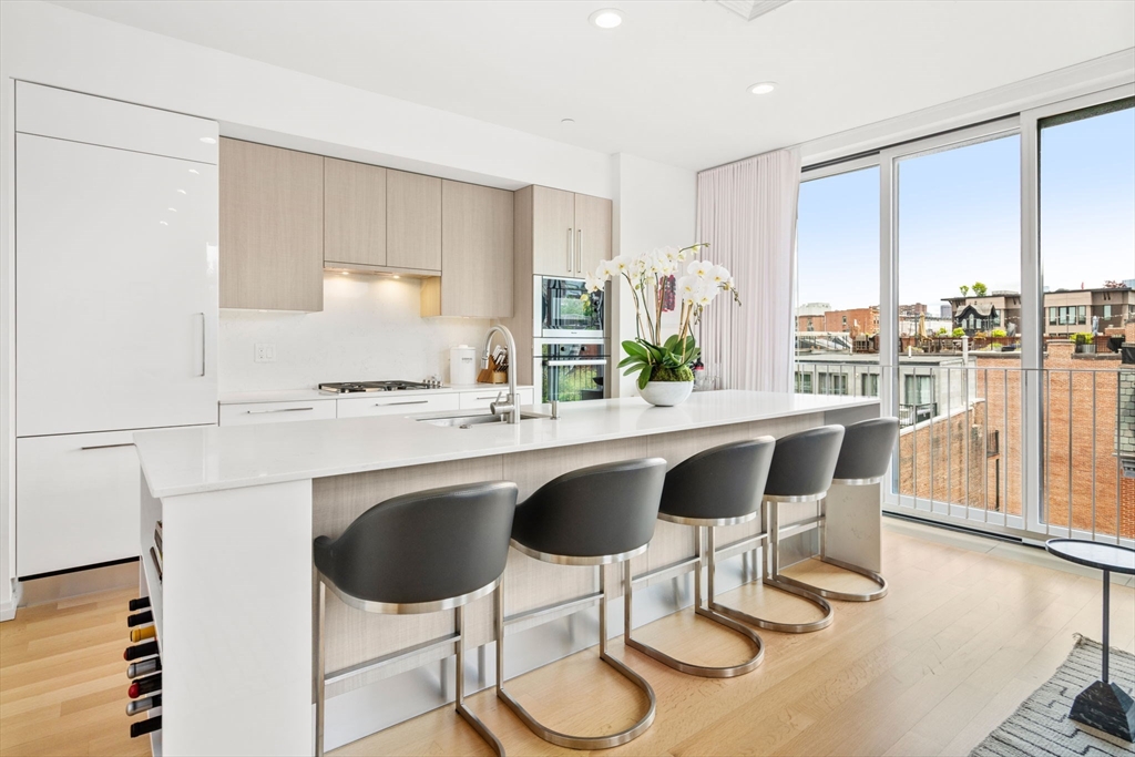 7 East Springfield Street, Unit 5B Boston, MA 02118 - Photo 1 of 19 a dining room with furniture and large windows
