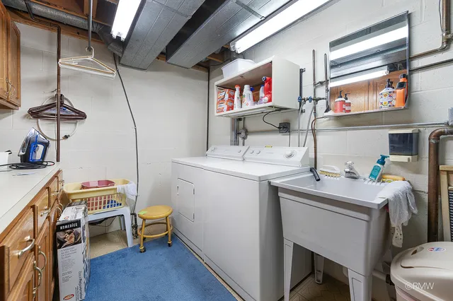 a room with sink cabinets and appliances