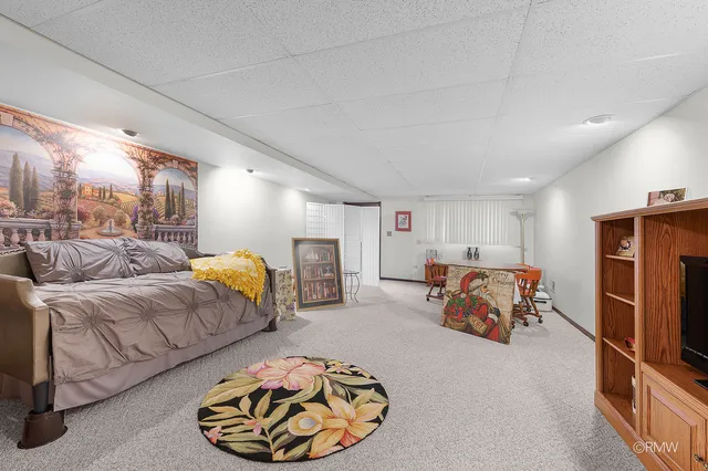 a bedroom with furniture and a lamp