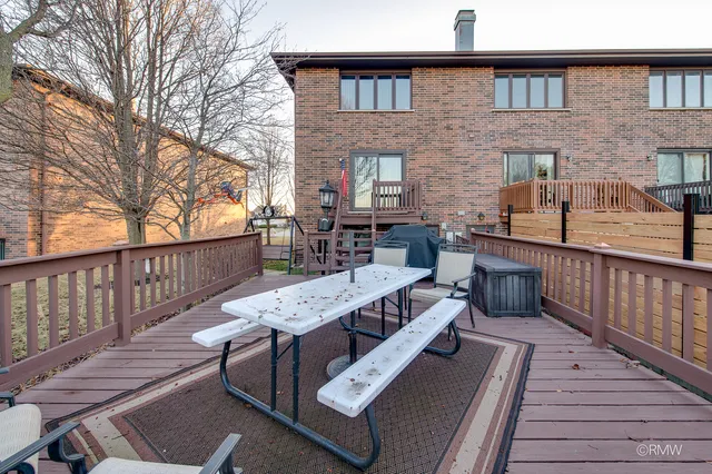 a view of a deck with couches wooden floor and fence