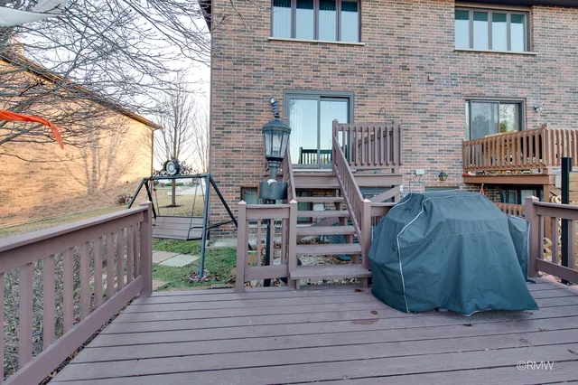 a view of a deck with wooden floor and fence