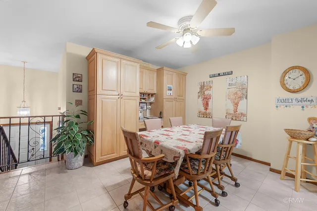 a view of a dining room with furniture and a chandelier