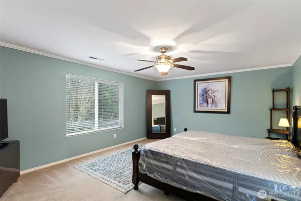 a bedroom with a large bed and a window