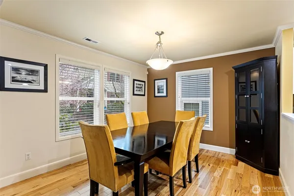 a view of a dining room with furniture window and wooden floor