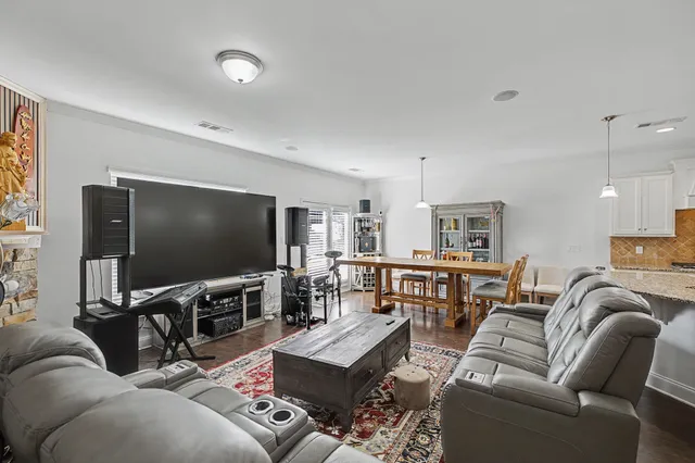 a large kitchen with kitchen island a sink table and chairs