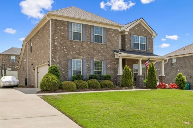 a front view of a house with garden