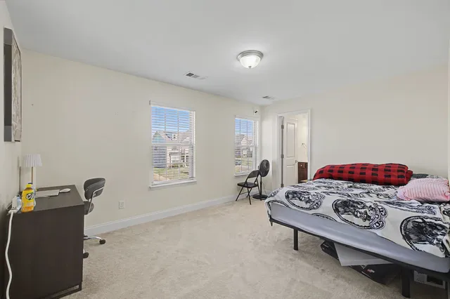 a bathroom with a sink a toilet a mirror and shower