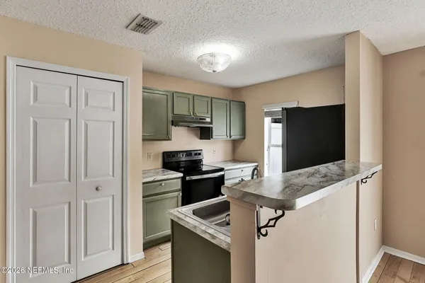a kitchen with a refrigerator stove and sink