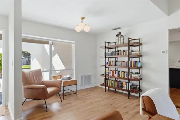 a living room with fireplace furniture and decor