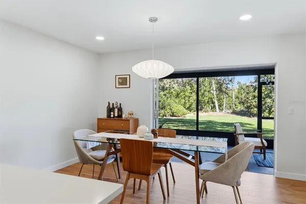 a dining room with furniture and a window