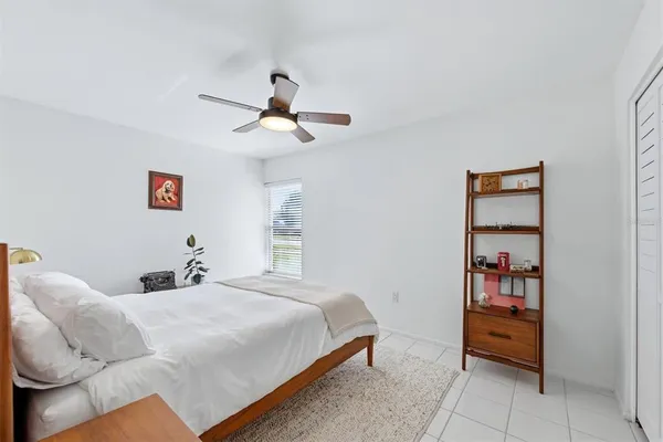 a bedroom with a bed and a painting on the wall