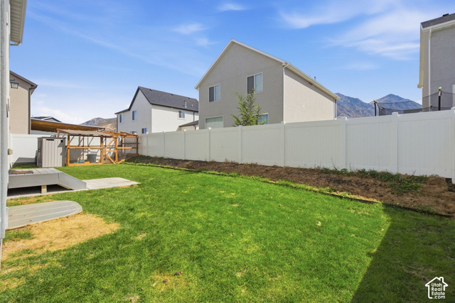 1113 South Raintree Lane Santaquin, UT 84655 - Photo 53 of 59 Expansive backyard featuring a manicured lawn, a full white privacy fence, and a built-in outdoor structure