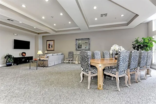 a living room with furniture a flat screen tv and kitchen view