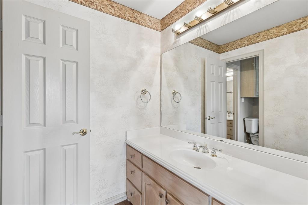 8517 Navigation Drive Rowlett, TX 75088 - Photo 33 of 39 a bathroom with a double vanity sink and a mirror