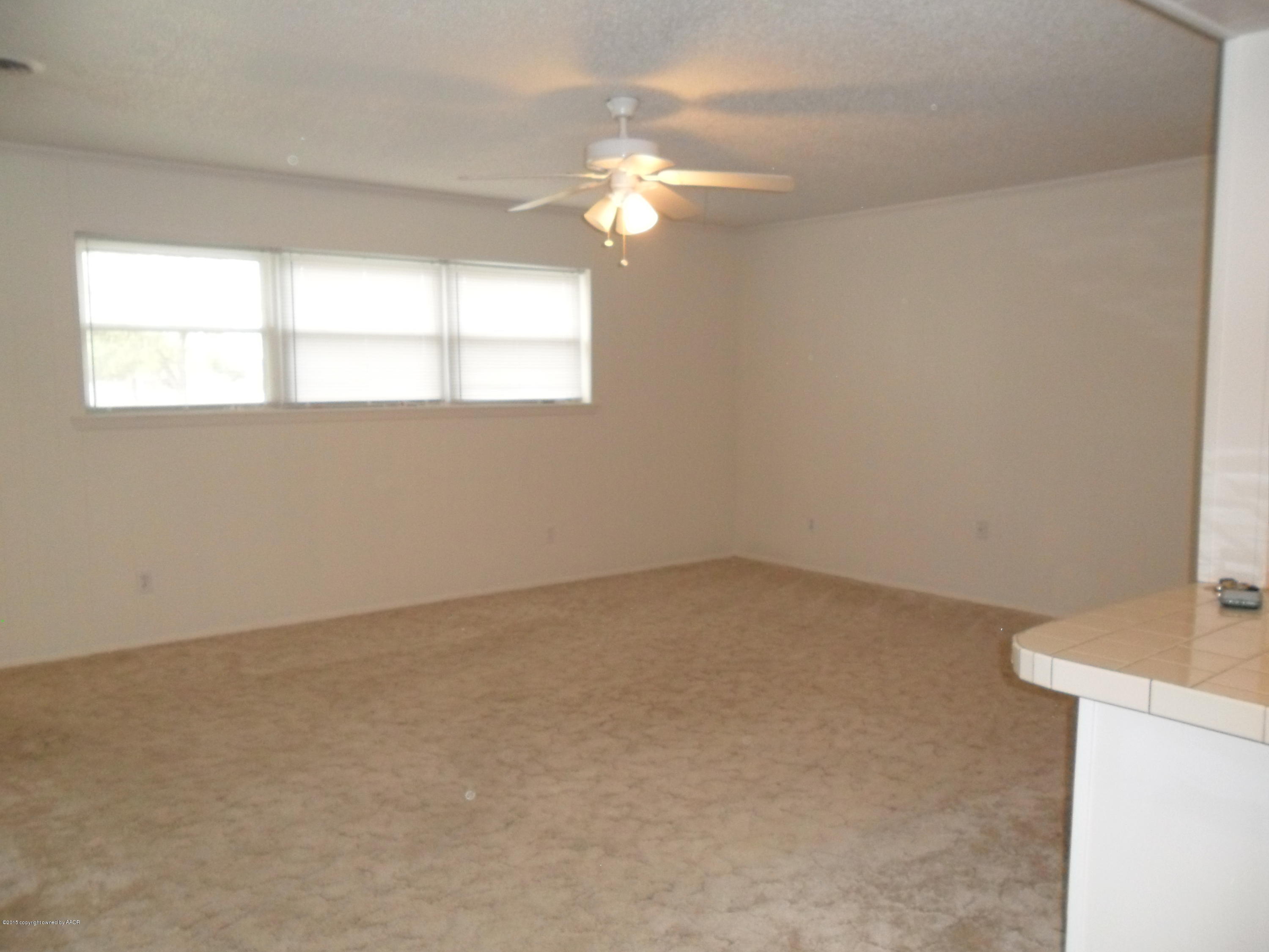 2216 Southwest 52nd Avenue Amarillo, TX 79110 - Photo 3 of 21 an empty room with a window