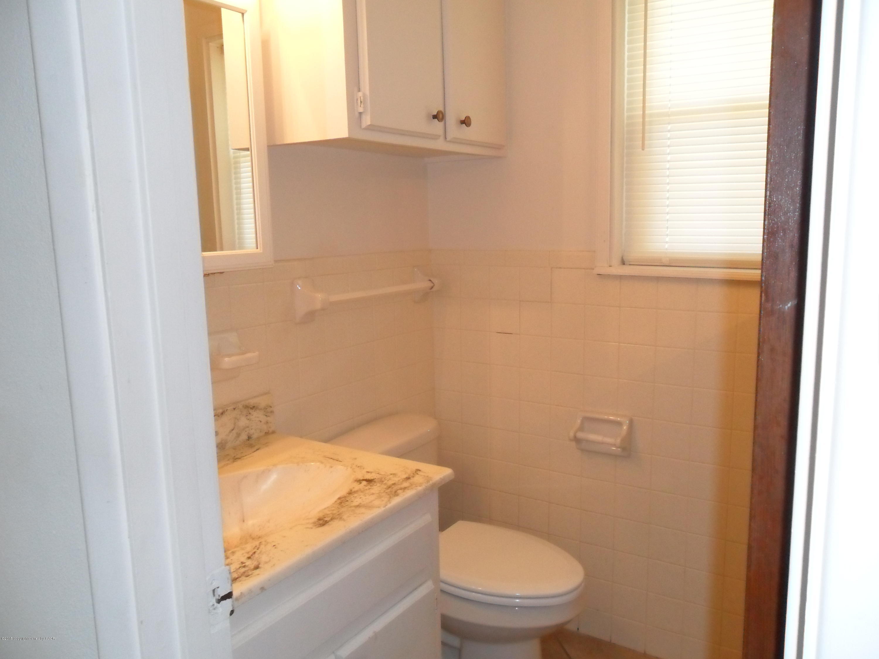2216 Southwest 52nd Avenue Amarillo, TX 79110 - Photo 8 of 21 a bathroom with a granite countertop toilet and a sink