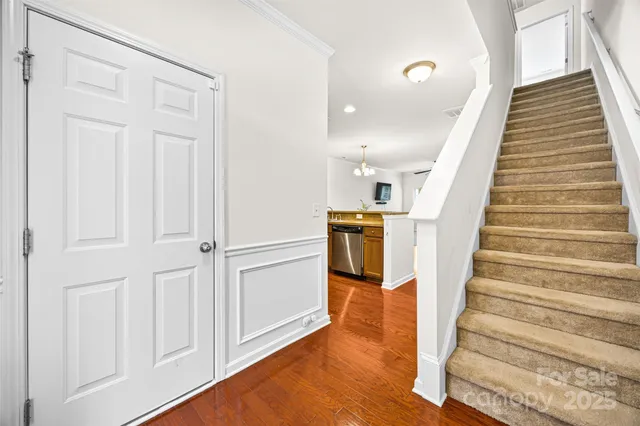 a view of entryway and hall with wooden floor