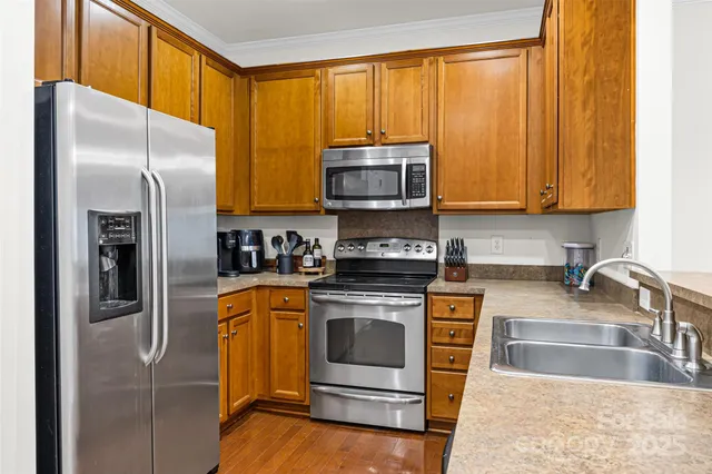 a kitchen with a refrigerator stove and microwave