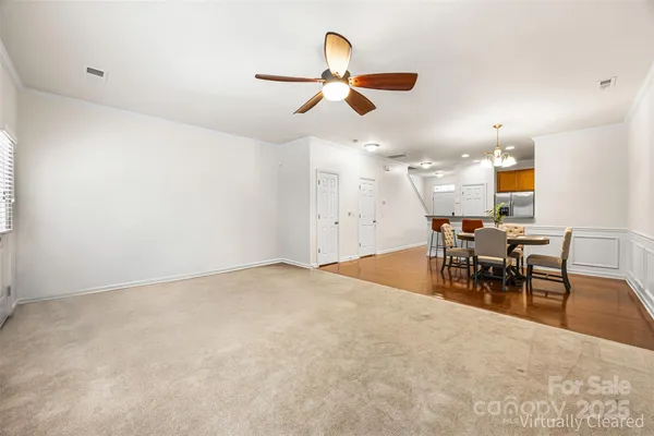 an empty room with furniture and fan