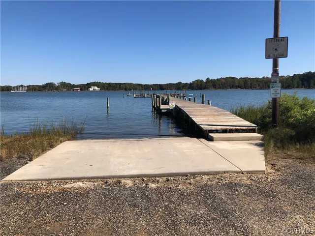 a view of a dry yard with wooden fence
