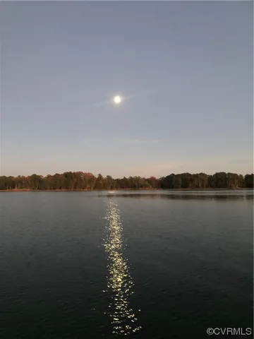 a view of a yard with wooden fence