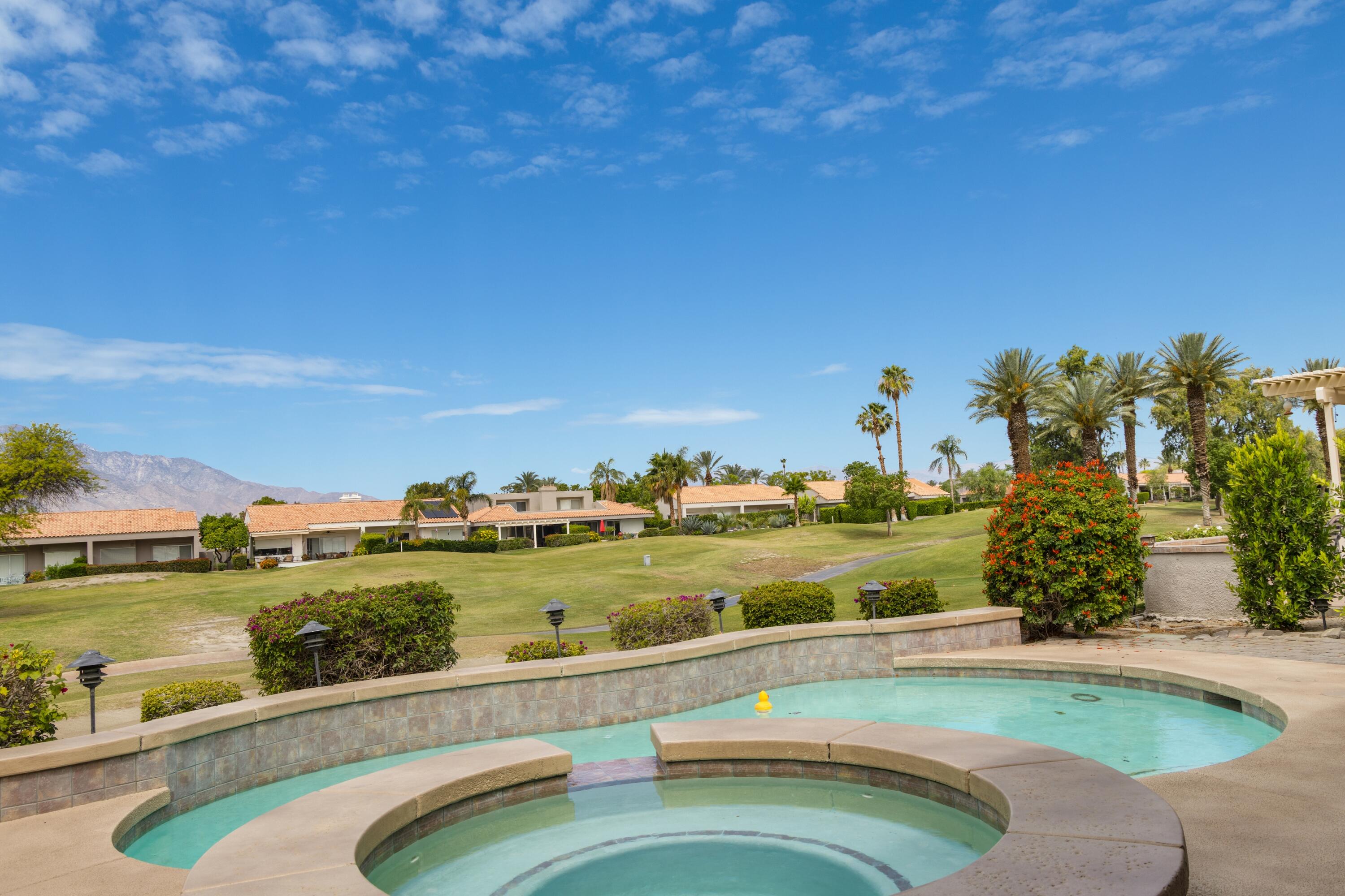 39 Augusta Drive Rancho Mirage, CA 92270 - Photo 50 of 53 a view of a swimming pool and an outdoor seating