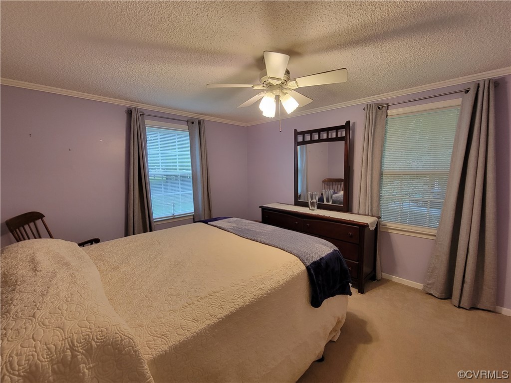 10301 Robbie Road Chesterfield, VA 23832 - Photo 15 of 21 a bedroom with a bed and a chandelier