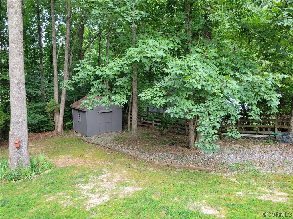 10301 Robbie Road Chesterfield, VA 23832 - Photo 18 of 21 a backyard of a house with plants and large trees