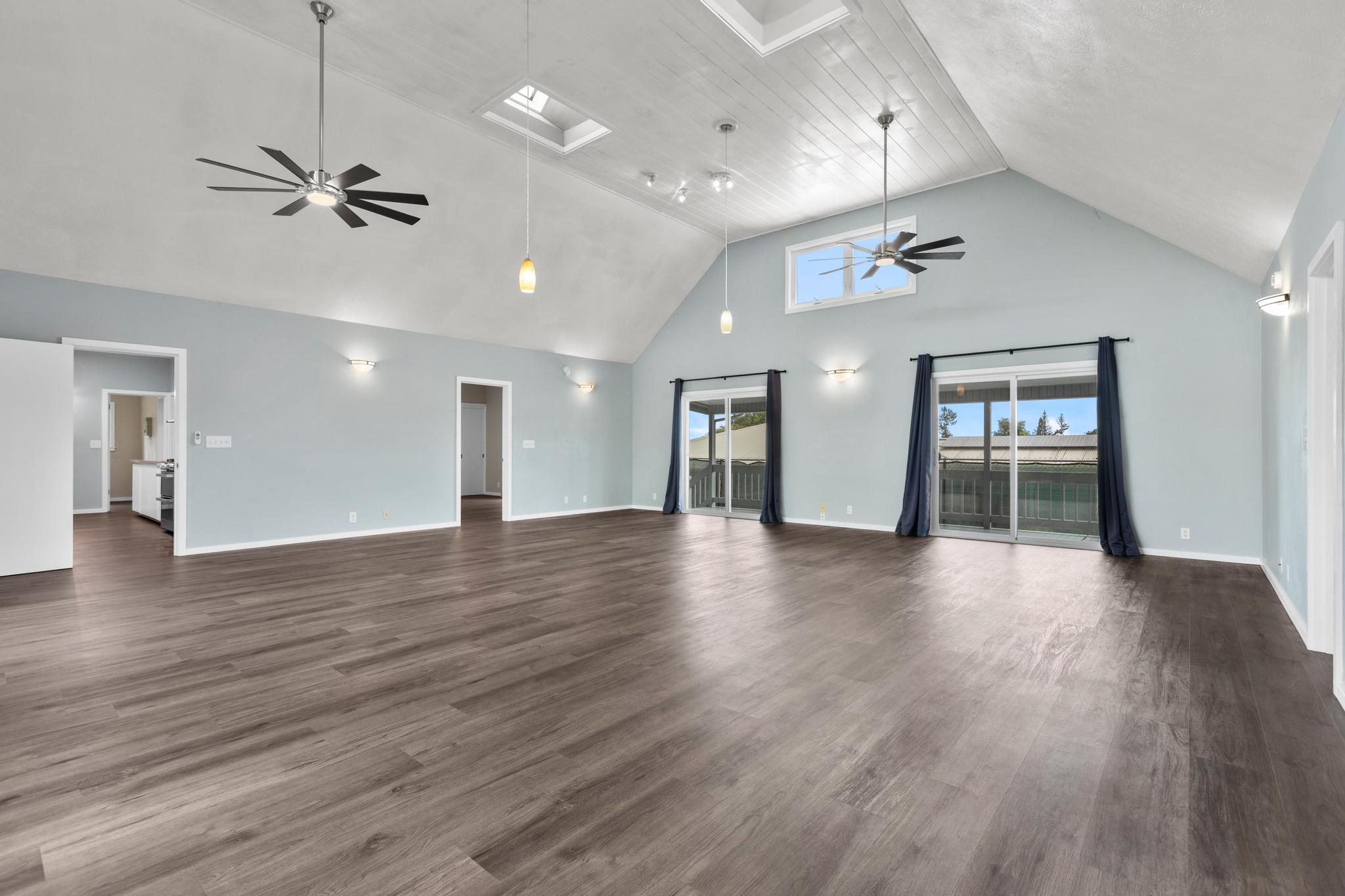 234 Kipa Street Hilo, HI 96720 - Photo 17 of 30 a view of an empty room with wooden floor and a ceiling fan