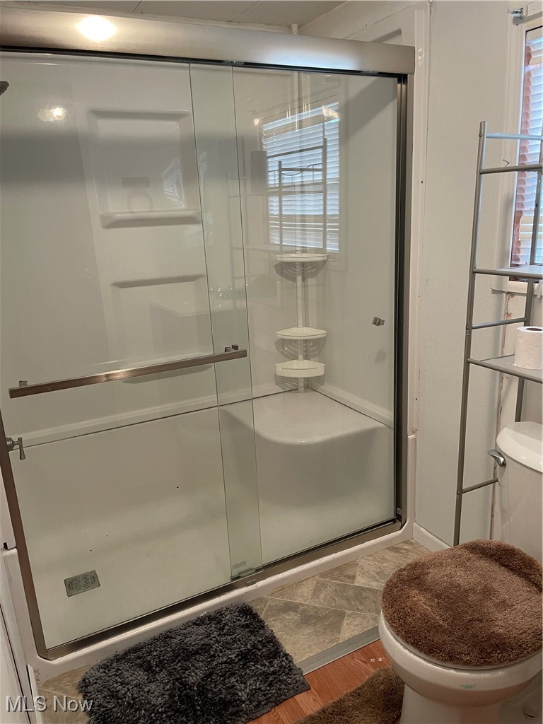 9329 Infirmary Road, Unit C13 Mantua, OH 44255 - Photo 8 of 9 Bathroom featuring a stall shower and wood finished floors