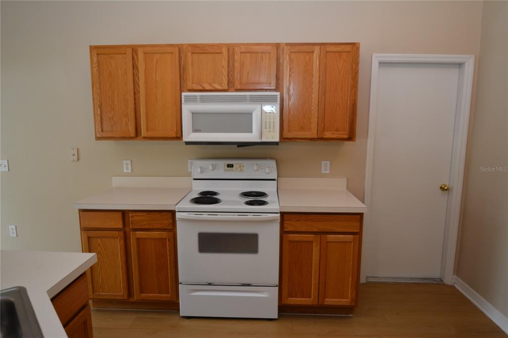 5 Kathleen Trail Palm Coast, FL 32164 - Photo 12 of 38 a kitchen with a stove and a microwave