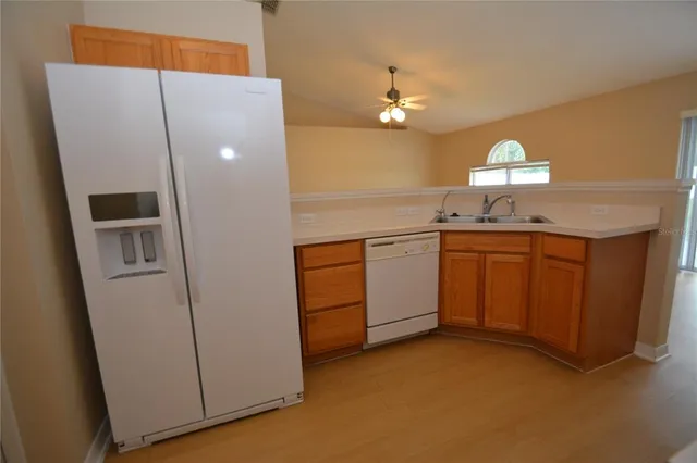 a kitchen with cabinets a sink and appliances