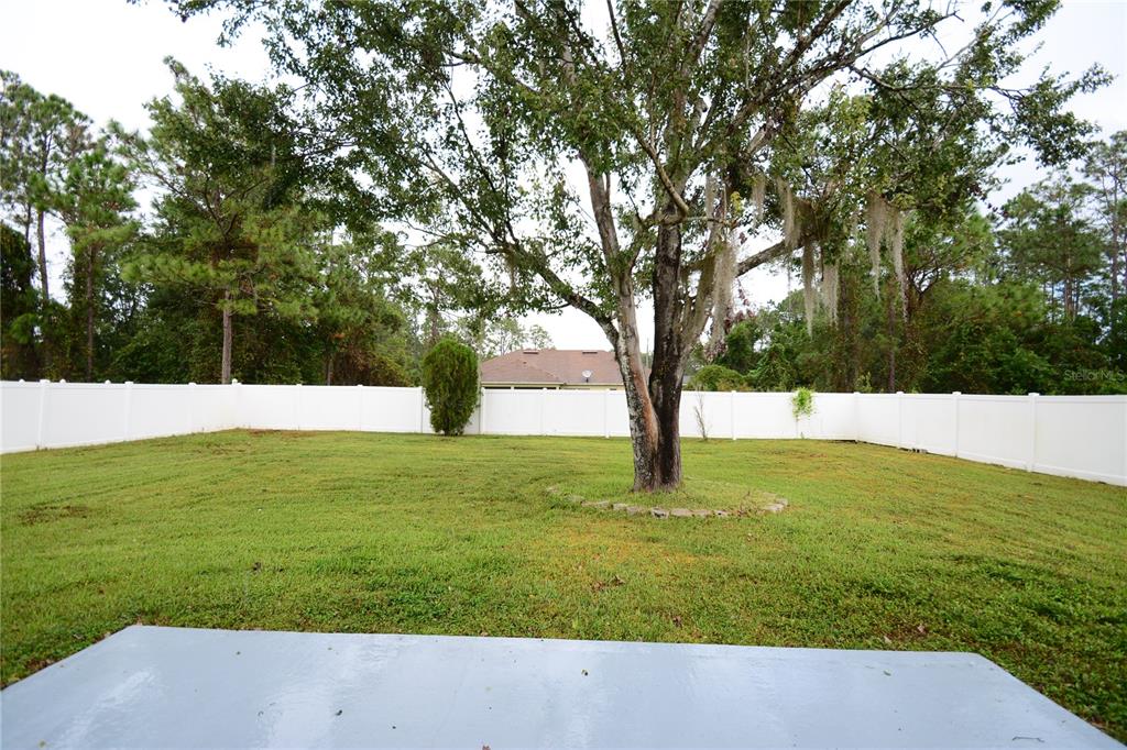 5 Kathleen Trail Palm Coast, FL 32164 - Photo 17 of 38 a view of yard with swimming pool and trees
