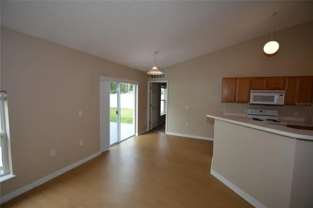 a view of a kitchen with a sink microwave and cabinets