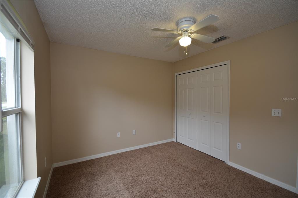 5 Kathleen Trail Palm Coast, FL 32164 - Photo 30 of 38 an empty room with closet and a chandelier fan