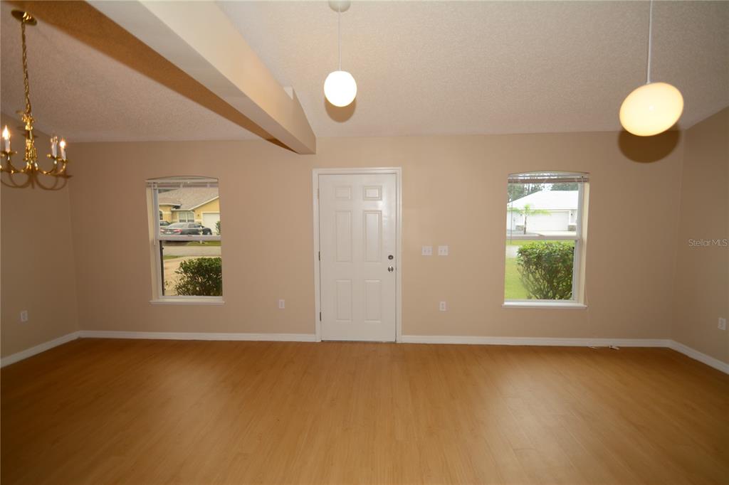 5 Kathleen Trail Palm Coast, FL 32164 - Photo 3 of 38 an empty room with windows and chandelier