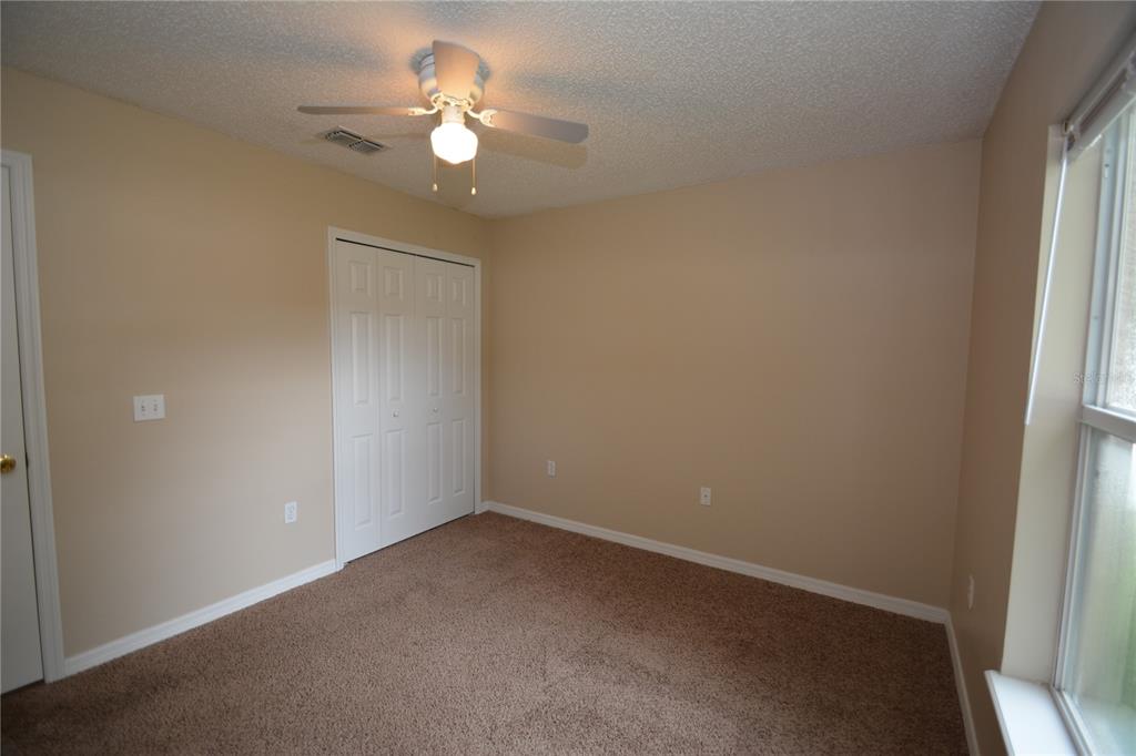 5 Kathleen Trail Palm Coast, FL 32164 - Photo 34 of 38 an empty room with a window and a fan
