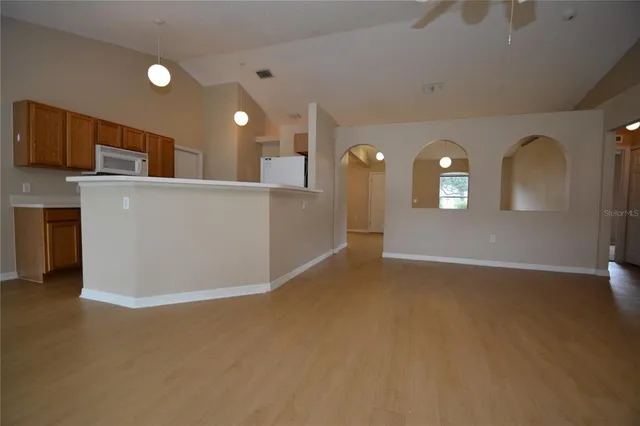 a view of a big room with windows and cabinet