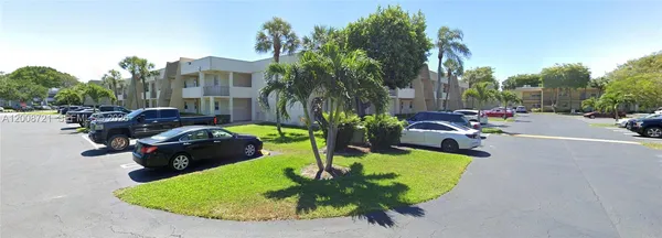 a view of a backyard with plants and patio